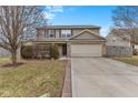 Traditional home featuring brick accents, a two-car garage, and a well-manicured front yard at 11617 Brook Bay Ln, Indianapolis, IN 46229