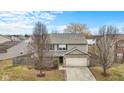 Charming two-story home featuring a two-car garage, well-maintained lawn, and mature trees at 11617 Brook Bay Ln, Indianapolis, IN 46229
