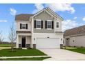 Charming two-story home featuring a gray and white color scheme, a two-car garage, and a well-manicured lawn at 1833 James Pierce Dr, Shelbyville, IN 46176