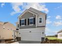 Two-story home with a two-car garage, gray shingles and white siding against a blue sky at 1833 James Pierce Dr, Shelbyville, IN 46176