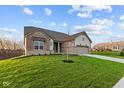 Ranch home with attractive landscaping and driveway at 4996 Hummingbird Dr, Brownsburg, IN 46112
