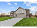 Side view of ranch home showcasing garage and landscaping at 4996 Hummingbird Dr, Brownsburg, IN 46112