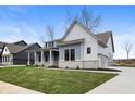Beautiful single-Gathering home with gray siding, stone accents, a covered porch, and manicured lawn at 1433 Chatham Hills Blvd, Westfield, IN 46074