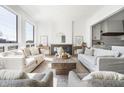 Spacious living room with modern fireplace, neutral decor, and abundant natural light at 11896 Spring Mill Rd, Carmel, IN 46032