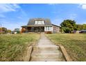 Brick home with a porch and manicured lawn at 232 N Church St, Morgantown, IN 46160