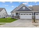 Charming home featuring a gray facade, a two-car garage, and a well-manicured front lawn at 3537 Wrangler Dr, Bargersville, IN 46106