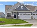 Charming home featuring a gray facade, a two-car garage, and a well-manicured front lawn at 3537 Wrangler Dr, Bargersville, IN 46106
