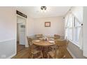 Bright dining room with a round wooden table and chairs, lit by natural light at 5890 Kingsley Dr, Indianapolis, IN 46220