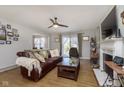 Inviting living room featuring hardwood floors, a ceiling fan, and sliding glass doors at 5890 Kingsley Dr, Indianapolis, IN 46220