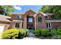 Beautiful two-story brick home featuring a manicured lawn, arched entryway, and large windows at 808 Copperfield Xing, Danville, IN 46122