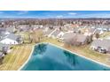 Aerial view shows community pond with walking path surrounded by well-maintained residential properties at 1463 Hamilton Dr, Greenwood, IN 46143