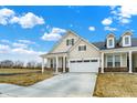 Charming home exterior featuring a well-maintained lawn, a wide driveway, and lovely architectural details at 18425 Depoe Ln, Westfield, IN 46074