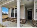Inviting front porch with brick accents, sturdy white columns, and a view of the lawn at 18425 Depoe Ln, Westfield, IN 46074