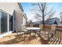 Backyard deck, with a glass-topped table and seating, offers space for outdoor enjoyment at 719 Trent Dr, Greenwood, IN 46143
