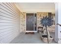 Inviting covered front porch and entry with brick accents and beautiful decor at 719 Trent Dr, Greenwood, IN 46143