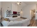 Spacious living room with an electric fireplace, shelving, and an over-sized grey couch at 8118 Ambrosia Ln, Pendleton, IN 46064