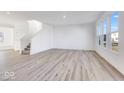 Large living room with hardwood floors and stairs at 1116 Bevy Blvd, Danville, IN 46122
