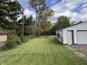 Spacious backyard with a well-maintained lawn and a detached garage at 3305 N Keystone Ave, Indianapolis, IN 46218