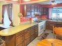 Traditional kitchen with wood cabinetry, light countertops, and a cozy breakfast nook near a large window at 3305 N Keystone Ave, Indianapolis, IN 46218