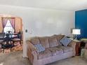 Comfortable living room with a plush couch, vibrant blue wall, and elegant dining area visible at 3305 N Keystone Ave, Indianapolis, IN 46218