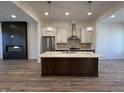 Modern kitchen features a large island, stainless steel appliances, and pendant lighting, perfect for cooking and entertaining at 468 W Smoky Row, Carmel, IN 46032