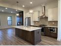 Gourmet kitchen with a central island, stainless appliances, and tile backsplash providing a chef's dream space at 468 W Smoky Row, Carmel, IN 46032
