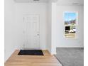 Bright entryway featuring a front door, wood floors, and a window that provides natural light at 475 Chester Ln, Pittsboro, IN 46167