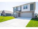 A charming two-story home with a spacious driveway and well-maintained lawn, ideal for suburban living at 1217 Fleming Dr, Greenfield, IN 46140
