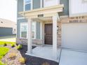 Inviting front entrance with a covered porch, brick accents, and well-manicured landscaping at 1217 Fleming Dr, Greenfield, IN 46140