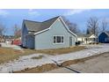 Side view of charming blue house with gray door, showcasing curb appeal at 405 E 9Th St, Sheridan, IN 46069