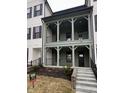 Inviting two-story home with a charming covered porch and well-manicured landscaping at 460 W Smoky Row, Carmel, IN 46032