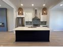 Modern kitchen featuring a large center island, stainless steel appliances, and stylish lighting at 460 W Smoky Row, Carmel, IN 46032