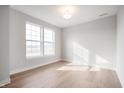 Bright bedroom with hardwood floors, large windows, and neutral paint, offering a serene living space at 12013 Gia Ct, Noblesville, IN 46060