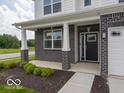 Inviting front porch with brick pillars, dark brick accents, and a stylish front door at 236 Sam Himsel Way, Danville, IN 46122