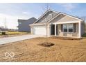Two-story house with gray siding and brick accents, featuring a front yard at 6036 Card Blvd, Indianapolis, IN 46221