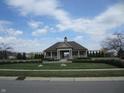 Community building with covered patio and well-maintained landscaping on a sunny day at 12912 Broncos Dr, Fishers, IN 46037