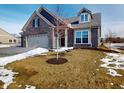 Brick house with 2-car garage and a partially snow covered front yard at 5009 Carmine St, Brownsburg, IN 46112