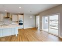 Spacious kitchen with island, stainless steel appliances, and hardwood floors at 5009 Carmine St, Brownsburg, IN 46112