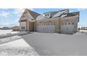 Brick home with three-car garage. Snow on the ground at 5034 Bergamot Dr, Brownsburg, IN 46112