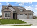 Charming single-story home with a well-manicured lawn, brick facade, and two-car garage at 5034 Bergamot Dr, Brownsburg, IN 46112