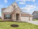 Brick house with 3-car garage, stone accents and landscaping at 4998 Carmine St, Brownsburg, IN 46112