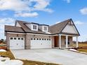 Brick house with three-car garage, dormer windows and gray roof at 5005 Carmine St, Brownsburg, IN 46112
