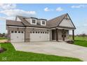 Stunning brick home with a three-car garage and a long driveway at 5005 Carmine St, Brownsburg, IN 46112