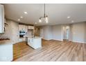 Open concept kitchen with island, stainless steel appliances, and light-colored cabinets at 5005 Carmine St, Brownsburg, IN 46112