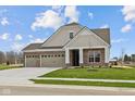 Beautiful single-story brick home with a three-car garage and well-manicured lawn at 5021 Carmine St, Brownsburg, IN 46112