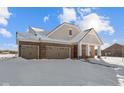 Brick ranch home with 2-car garage and snowy landscape at 5021 Carmine St, Brownsburg, IN 46112