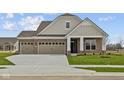 Charming single-story brick home with a three-car garage and a welcoming entrance at 5021 Carmine St, Brownsburg, IN 46112