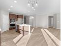 Open concept kitchen with island and hardwood floors at 5021 Carmine St, Brownsburg, IN 46112