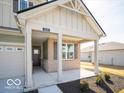 Welcoming front porch with classic columns and a cozy entryway, nestled within a friendly community at 245 Lar Lan Dr, Danville, IN 46122