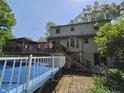 Two-story home's backyard features a pool, patio area, screened-in porch, and stairs leading to walkout basement at 6605 Donnelly Dr, Brownsburg, IN 46112
